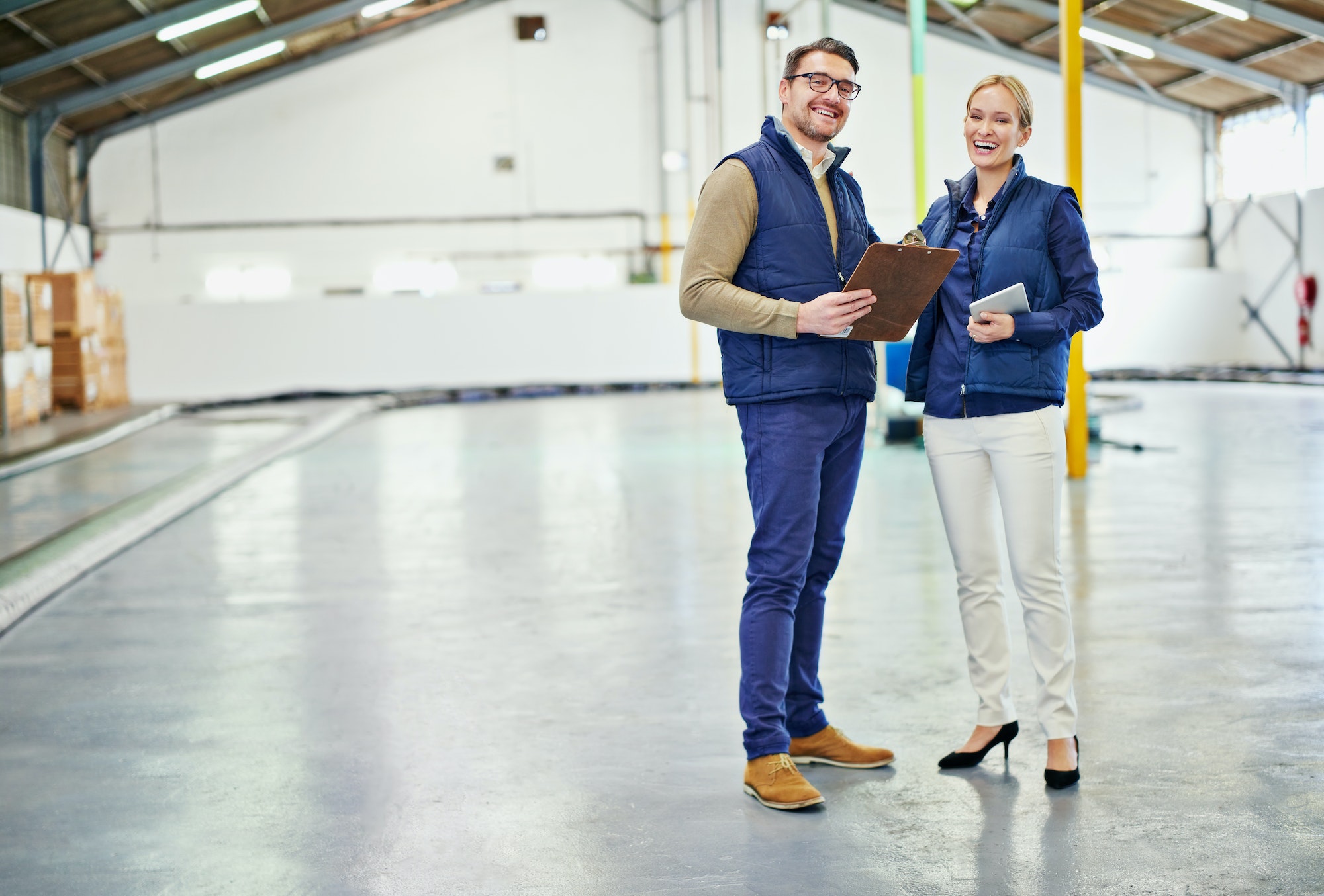 Clearing the warehouse floor. Portrait of two floor managers working in a large warehouse.