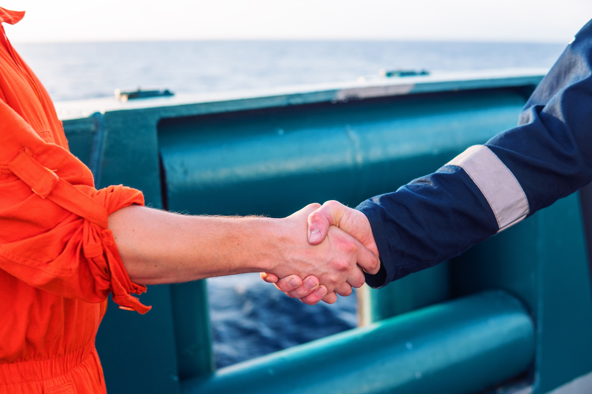 marine contractor businessman handshaking with worker on the ship